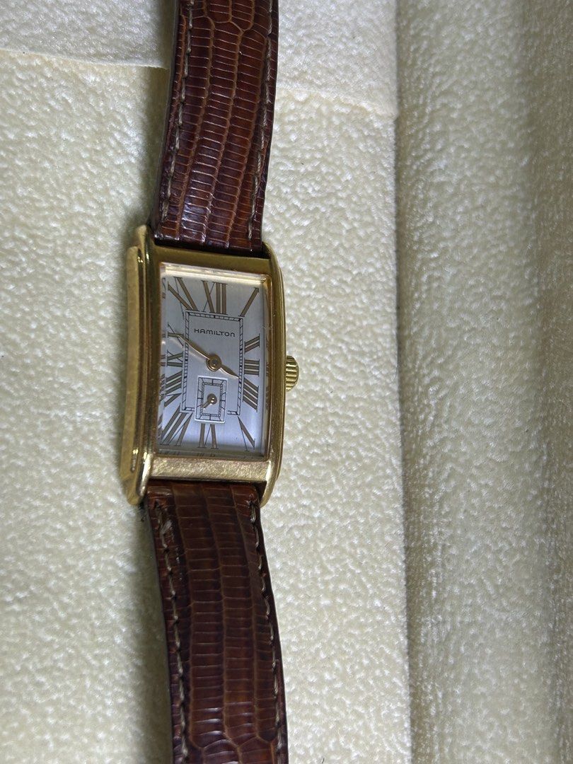 Hamilton rectangular gold dress watch with leather strap (Category: Luxury Watches) located in Manila. Submitted by japanarchivefinds (Listing ID 1470224322, Image 1). Description: - Brand: Hamilton rectangular dress watch - Color: Gold-tone polished case with silver dial and Roman numerals - Features: Small seconds sub-dial at 6 o'clock and battery-operated quartz movement - Strap: Brown lizard grain leather strap with pin buckle - Condition: Cl