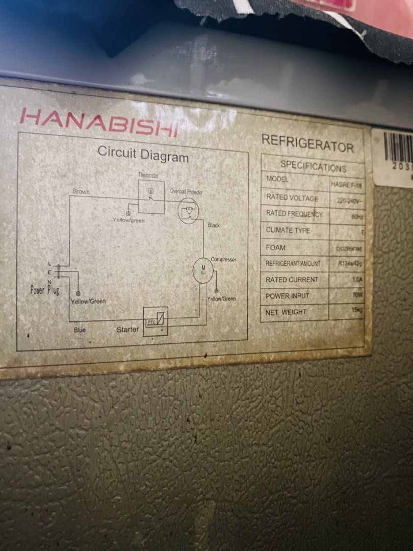 Hanabishi Mini Refrigerator HASREF-18 (Category: Refrigerators and Freezers) located in Makati City. Submitted by a_c_0_7 (Listing ID 1470271059, Image 3). Description: - Brand/Model: Hanabishi HASREF-18 Mini Ref - Color: Silver door body with yellow-toned edges - Design: Single door setup with a top mini freezer compartment - Condition: Powers on normally (220-240V, 60Hz), with visible rust at the bottom base frame - Features: Standard wire setu