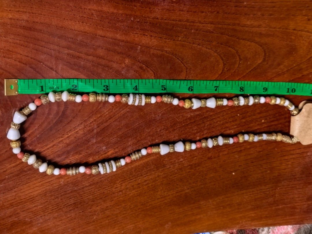 Handmade Beaded Necklace Gold White Coral (Category: Necklaces) located in Rizal. Submitted by gkstcenit (Listing ID 1470343752, Image 2). Description: - Handmade bohemian beaded necklace - Mix of white, coral pink, and gold-toned metal beads - Measures approx. 12 inches laid flat - Secure clasp closure stamped with "PAT." - Brand new on "Handmade with love" display card - Great everyday accessory.