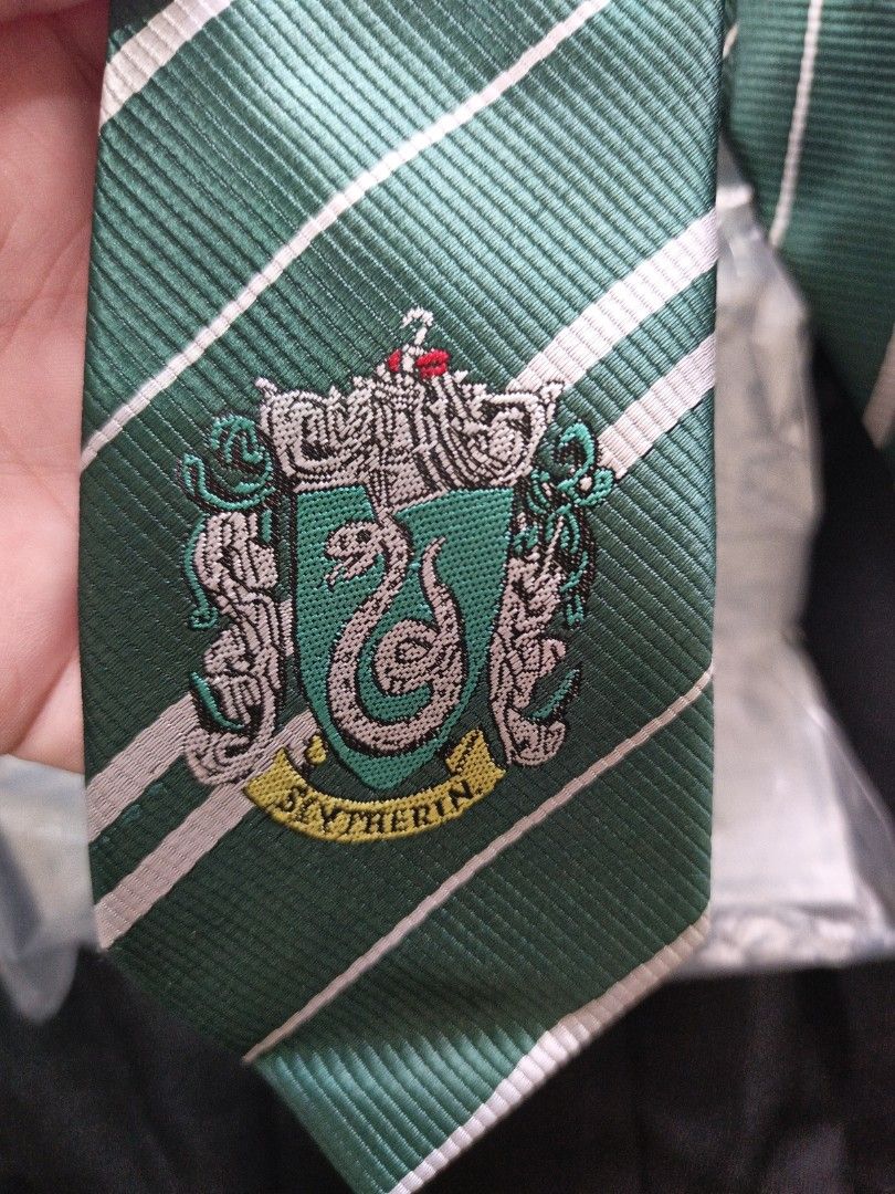 Harry Potter Slytherin Robe and Tie (Category: Coats, Jackets and Outerwear) located in Las Pinas. Submitted by lujlian (Listing ID 1470171021, Image 3). Description: - Slytherin House Set (Robe + Necktie) - Black hooded robe featuring signature green-trimmed inner lining - Detailed Slytherin snake crest embroidered on the chest - Matching green and silver striped necktie with crest at the bottom tip - Ideal for cosplay, Halloween parties, and th