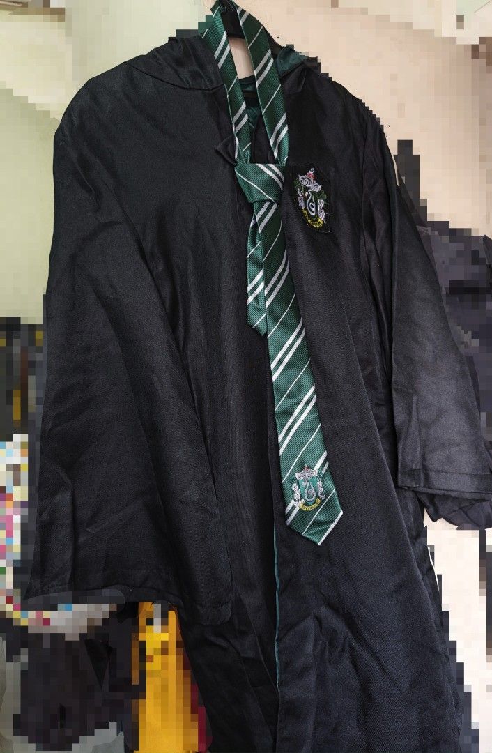Harry Potter Slytherin Robe and Tie (Category: Coats, Jackets and Outerwear) located in Las Pinas. Submitted by lujlian (Listing ID 1470171021, Image 1). Description: - Slytherin House Set (Robe + Necktie) - Black hooded robe featuring signature green-trimmed inner lining - Detailed Slytherin snake crest embroidered on the chest - Matching green and silver striped necktie with crest at the bottom tip - Ideal for cosplay, Halloween parties, and th