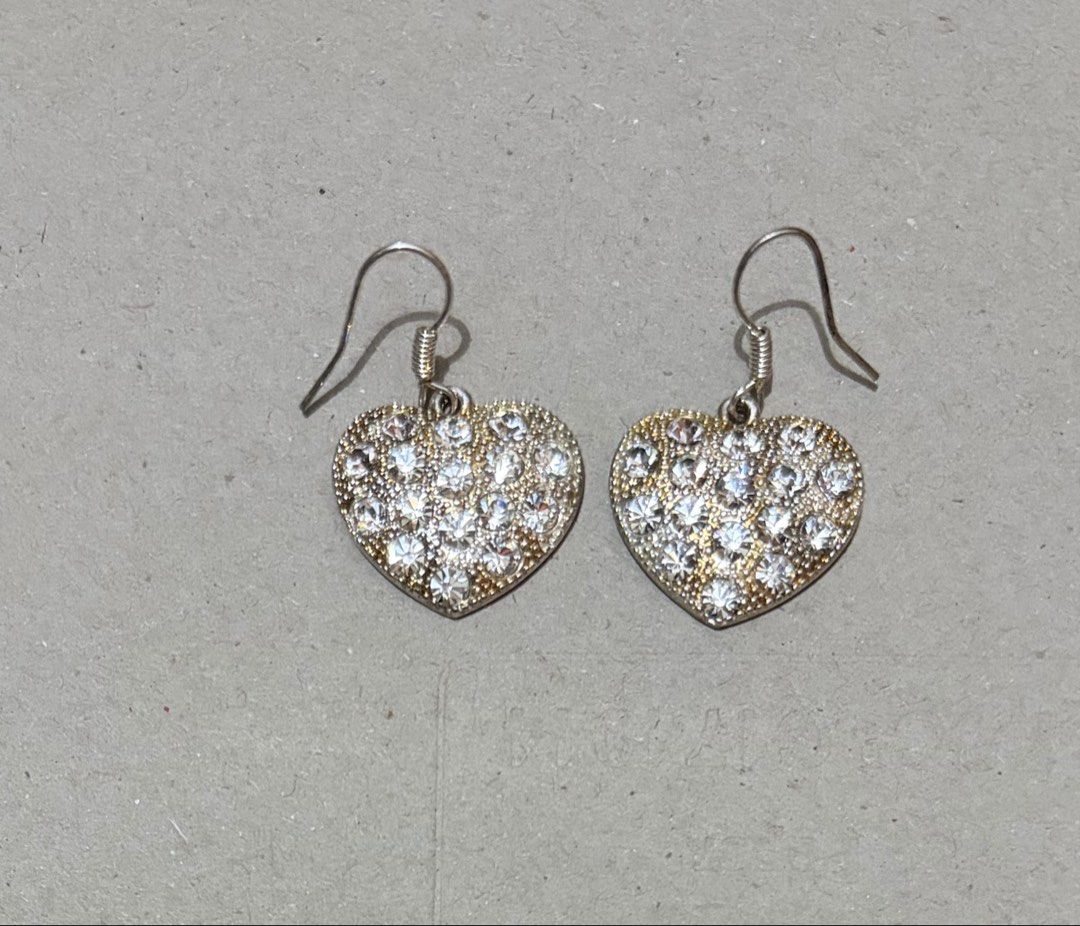 Heart Rhinestone Dangle Earrings Silver Tone (Category: Earrings) located in Quezon City. Submitted by garagesale2026 (Listing ID 1470348054, Image 1). Description: - Used once - Design: Heart-shaped dangle earrings covered in clear rhinestones - Details: Silver-tone wire hooks with spiral detail and textured backing - Sparkle: Catches the light beautifully for extra shine - Condition: Clean, well-maintained, and no missing stones.