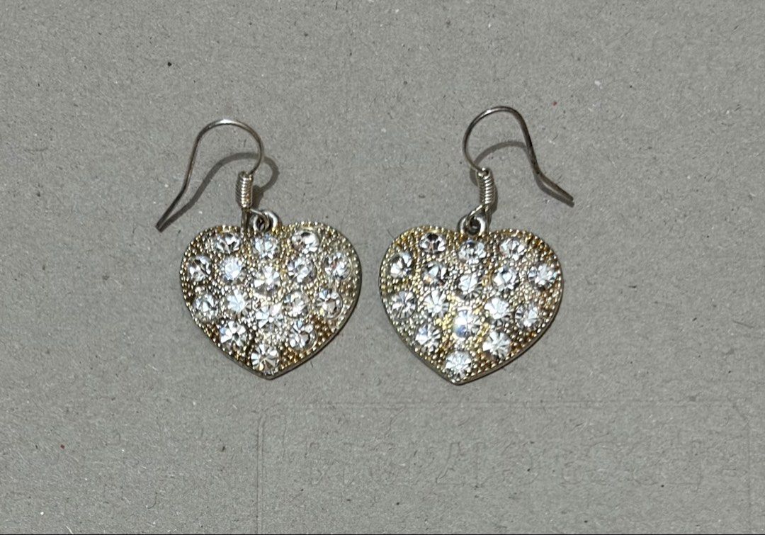 Heart Rhinestone Dangle Earrings Silver Tone (Category: Earrings) located in Quezon City. Submitted by garagesale2026 (Listing ID 1470348054, Image 2). Description: - Used once - Design: Heart-shaped dangle earrings covered in clear rhinestones - Details: Silver-tone wire hooks with spiral detail and textured backing - Sparkle: Catches the light beautifully for extra shine - Condition: Clean, well-maintained, and no missing stones.