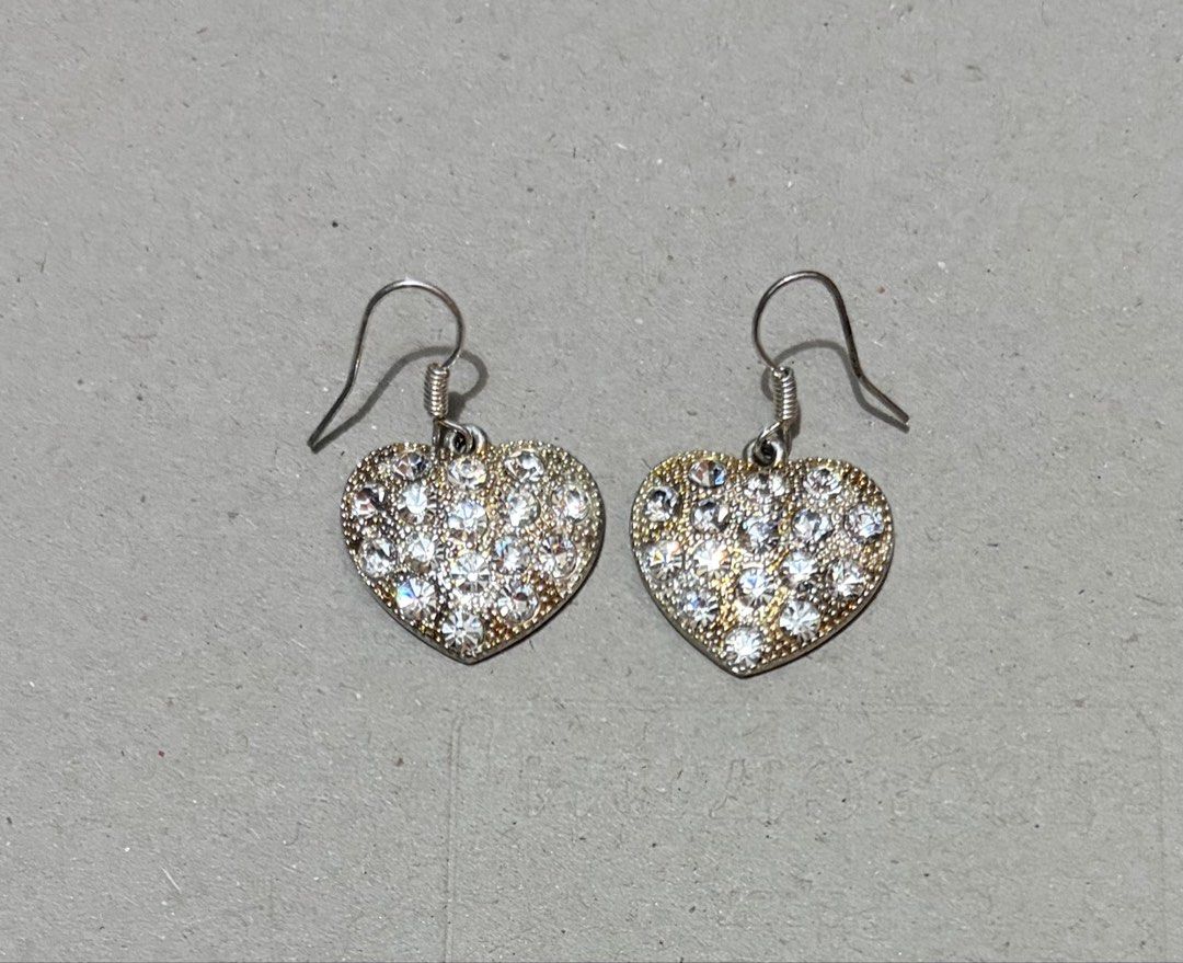 Heart Rhinestone Dangle Earrings Silver Tone (Category: Earrings) located in Quezon City. Submitted by garagesale2026 (Listing ID 1470348054, Image 3). Description: - Used once - Design: Heart-shaped dangle earrings covered in clear rhinestones - Details: Silver-tone wire hooks with spiral detail and textured backing - Sparkle: Catches the light beautifully for extra shine - Condition: Clean, well-maintained, and no missing stones.