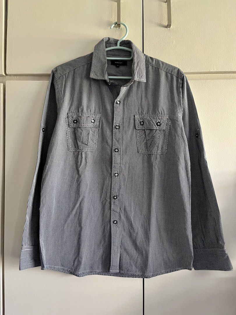 HEIST Men's Black and White Gingham Button-Down Shirt Size M (Category: Tshirts & Polo Shirts ) located in Pasig City. Submitted by TrishODeclutter (Listing ID 1470153075, Image 3). Description: - Brand/Style: HEIST button-down shirt - Pattern: Black and white gingham - Size: Medium - Features: Long sleeves with button cuffs, double chest pockets, classic collar, and front button fastening - Fabric: Lightweight and comfortable - Occasion: Perfect