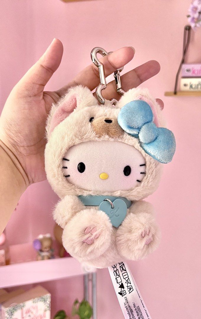 Hello Kitty Puppy Party Blind Box (Category: Plushies & Soft Toys) located in Imus. Submitted by muyingyingyinggg (Listing ID 1470237914, Image 1). Description: - Authentic Kitty plush keychain - Adorable fluffy pink animal hoodie with bear ears - Features a signature big blue bow and matching blue collar necklace - Cute heart pendant stamped with the letter 'K' - Equipped with a sturdy silver keyring and clasp - Includes original production tag 