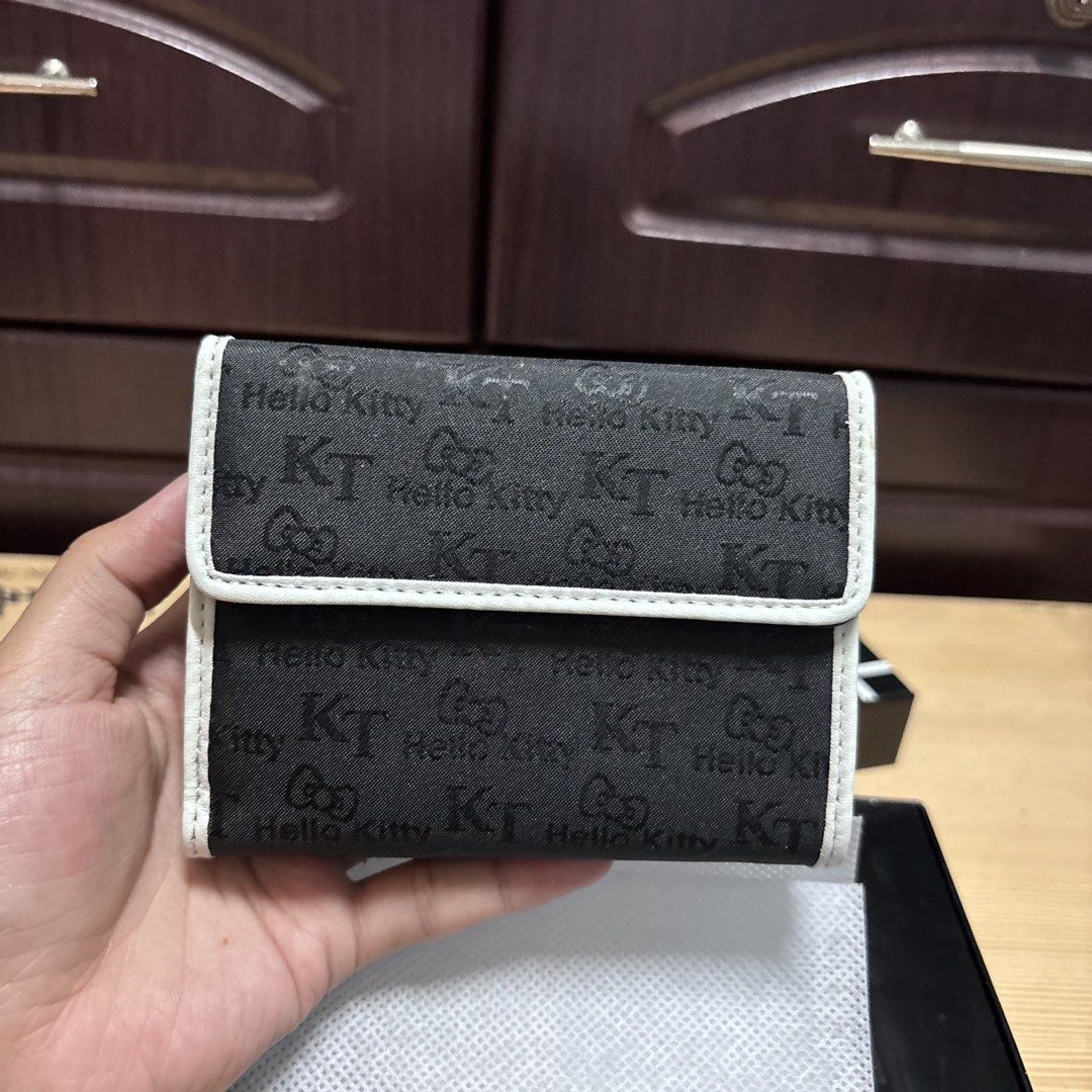 Hello Kitty Monogram Black and White Wallet with Box (Category: Wallets & Card holders) located in Manila. Submitted by nero.ph (Listing ID 1470348405, Image 1). Description: - Authentic Sanrio Kitty Monogram Wallet - Chic black and white design with KT logos and little bows - Secure snap flap closure and kiss-lock coin pouch compartment - Multiple card slots inside for easy organization - Comes complete with the original Sanrio branded black box