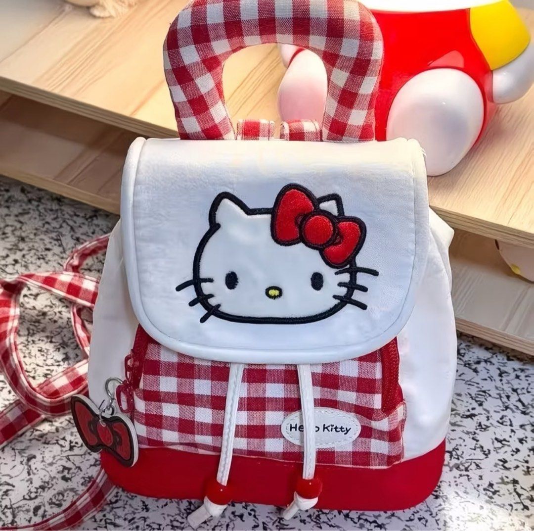 Hello Kitty Red Gingham Mini Backpack (Category: Backpacks) located in Manila. Submitted by ace02_ (Listing ID 1470177611, Image 1). Description: Super cute red and white gingham Kitty mini backpack! Features an embroidered Kitty face, cute bow zipper charm, and drawstring closure. Perfect for daily use or casual outings. Hello Kitty Bag ✨ Brand New Size: width: 26cm Height: 24cm.