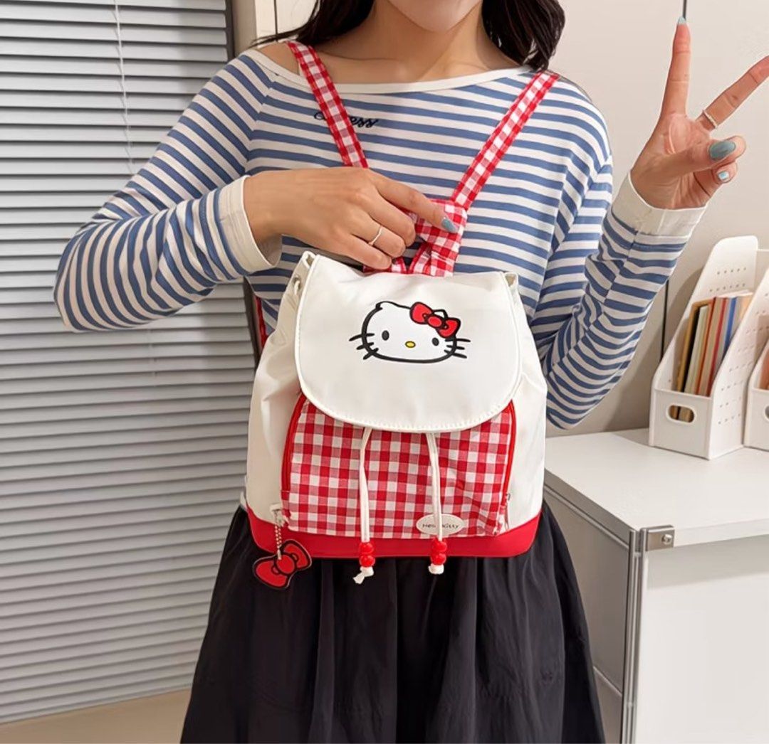 Hello Kitty Red Gingham Mini Backpack (Category: Backpacks) located in Manila. Submitted by ace02_ (Listing ID 1470177611, Image 2). Description: Super cute red and white gingham Kitty mini backpack! Features an embroidered Kitty face, cute bow zipper charm, and drawstring closure. Perfect for daily use or casual outings. Hello Kitty Bag ✨ Brand New Size: width: 26cm Height: 24cm.