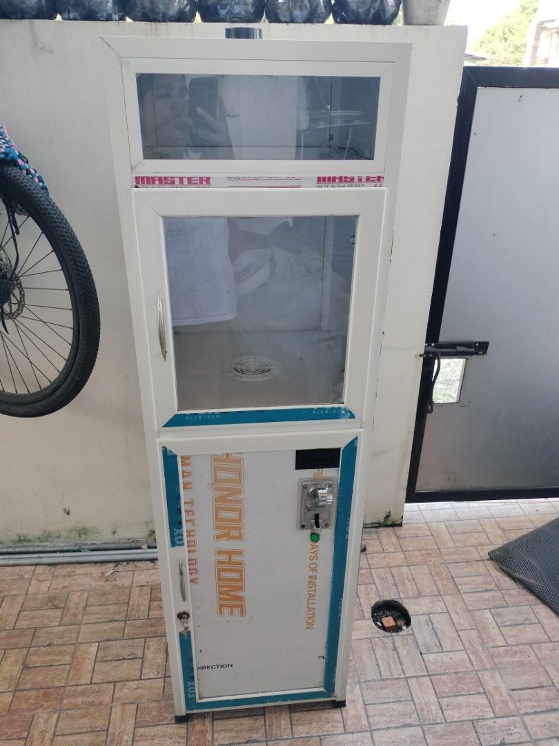 Helmet Vacuum machine (Category: Virtual Reality) located in Bulacan. Submitted by epicriver.0ac812 (Listing ID 1470155258, Image 1). Description: - White aluminum cabinet with glass doors - Lower compartment includes wiring, circuit boards, and digital display - Equipped with internal cooling fa n, ventilation duct, and lighting tubes - Features Master and Honor Home branding stickers - Clean interior with built-in ventilation grilles - Solid co