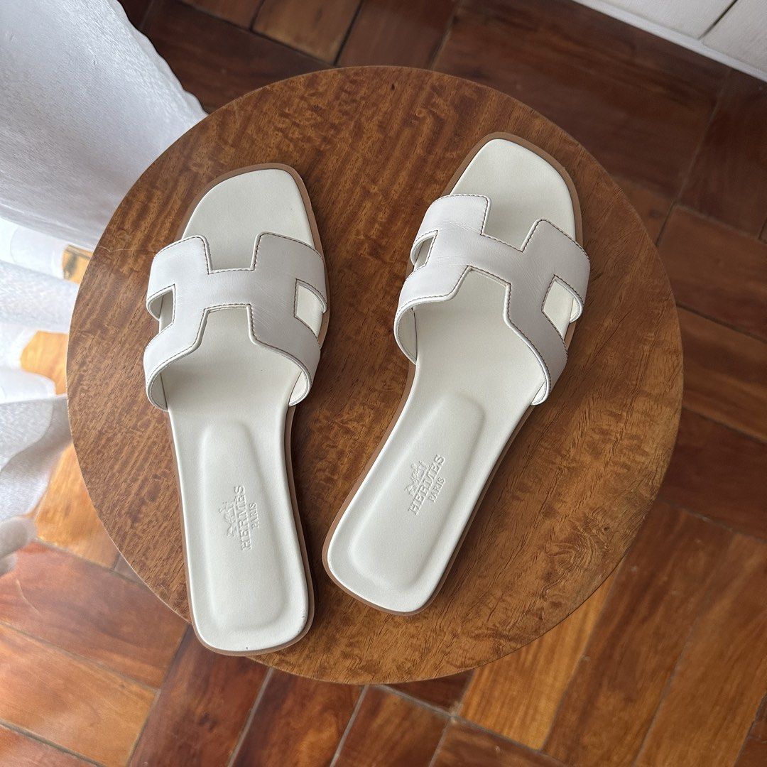 Hermes Oran sandals (Category: Sneakers & Footwear) located in San Juan City. Submitted by iy.am (Listing ID 1470183686, Image 1). Description: - Hermès Oran sandals in blanc/white - Size 36 / 23 cm - Already has sole protectors installed - Comes with box and dustbags - Has ordinary signs of wear but well-maintained (cleaned after each use) and still in good condition - Selling to buy another pair in my true size - Brand new retails for $900 now 