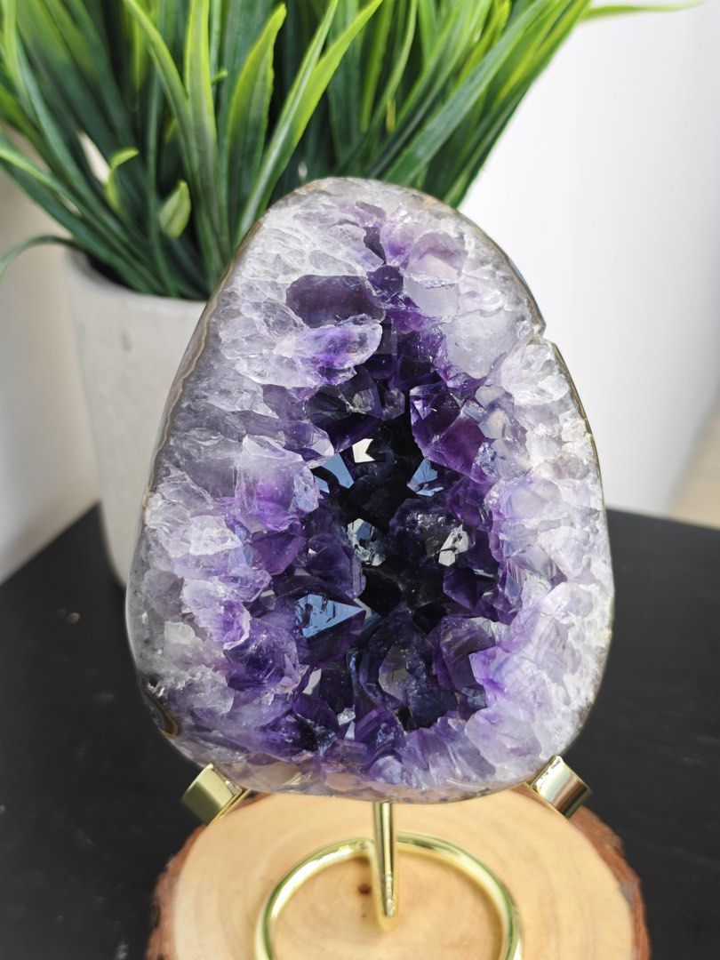 High Quality Uruguay Amethyst Geode Crystal Cluster on Stand (Category: Other Home Decor) located in Paranaque City. Submitted by heyandeey (Listing ID 1470166778, Image 2). Description: - Deep purple amethyst geode with a dark inner cavity and sparkling crystal points - Securely mounted on a stylish clear acrylic stand with gold-tone prongs - Heavy, natural stone formation perfect for desks, shelves, or altars - Stand is already included in the 