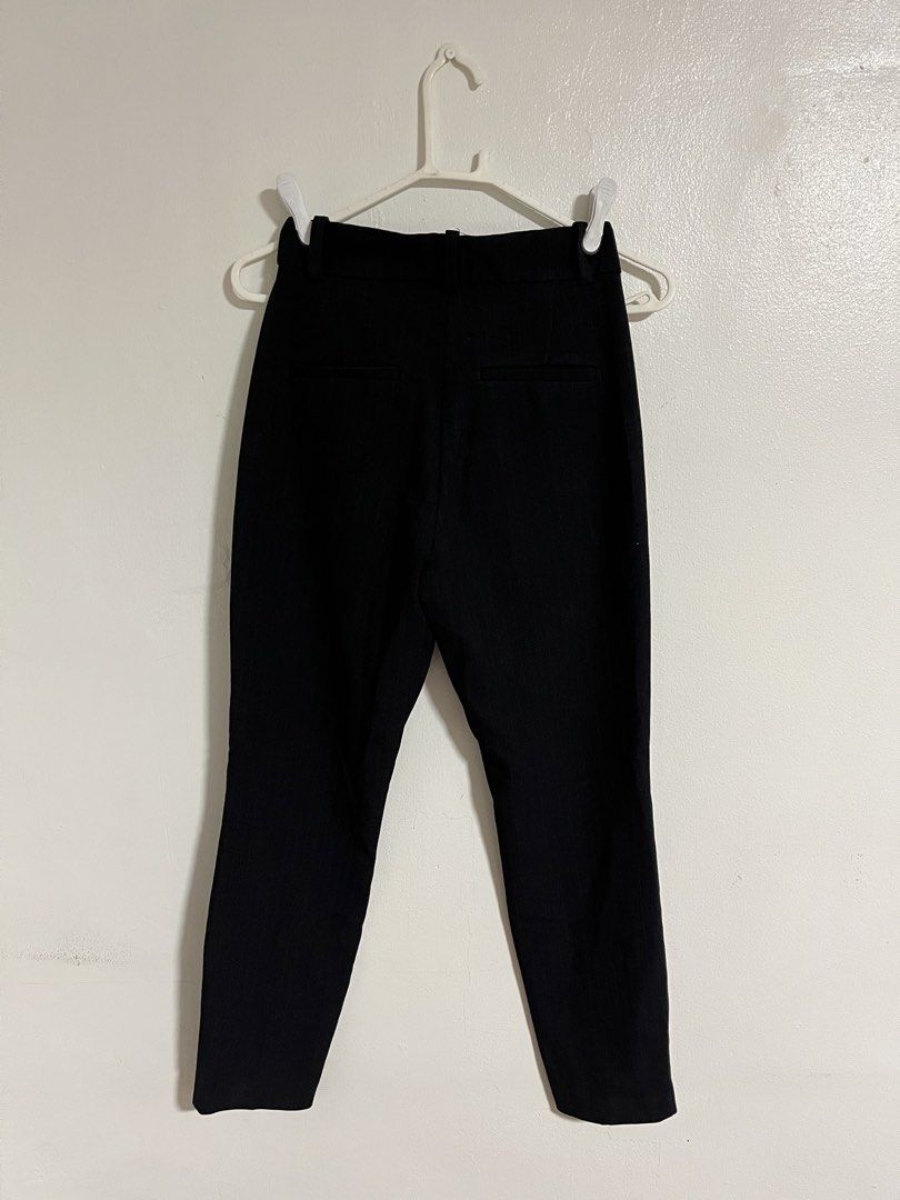H&M Black Pinstripe Trousers (Category: Other Bottoms) located in Cabuyao City. Submitted by rdtrmt (Listing ID 1470345669, Image 3). Description: - Brand: H&M - Size: US 2 / EUR 34 - Color: Black with subtle vertical pinstripes - Style: Fitted, ankle-length trousers - Waist: Elasticized in the back with belt loops - Pockets: Functional front pockets and decorative back pockets - Condition: Clean, excellent, overall still in good condition.