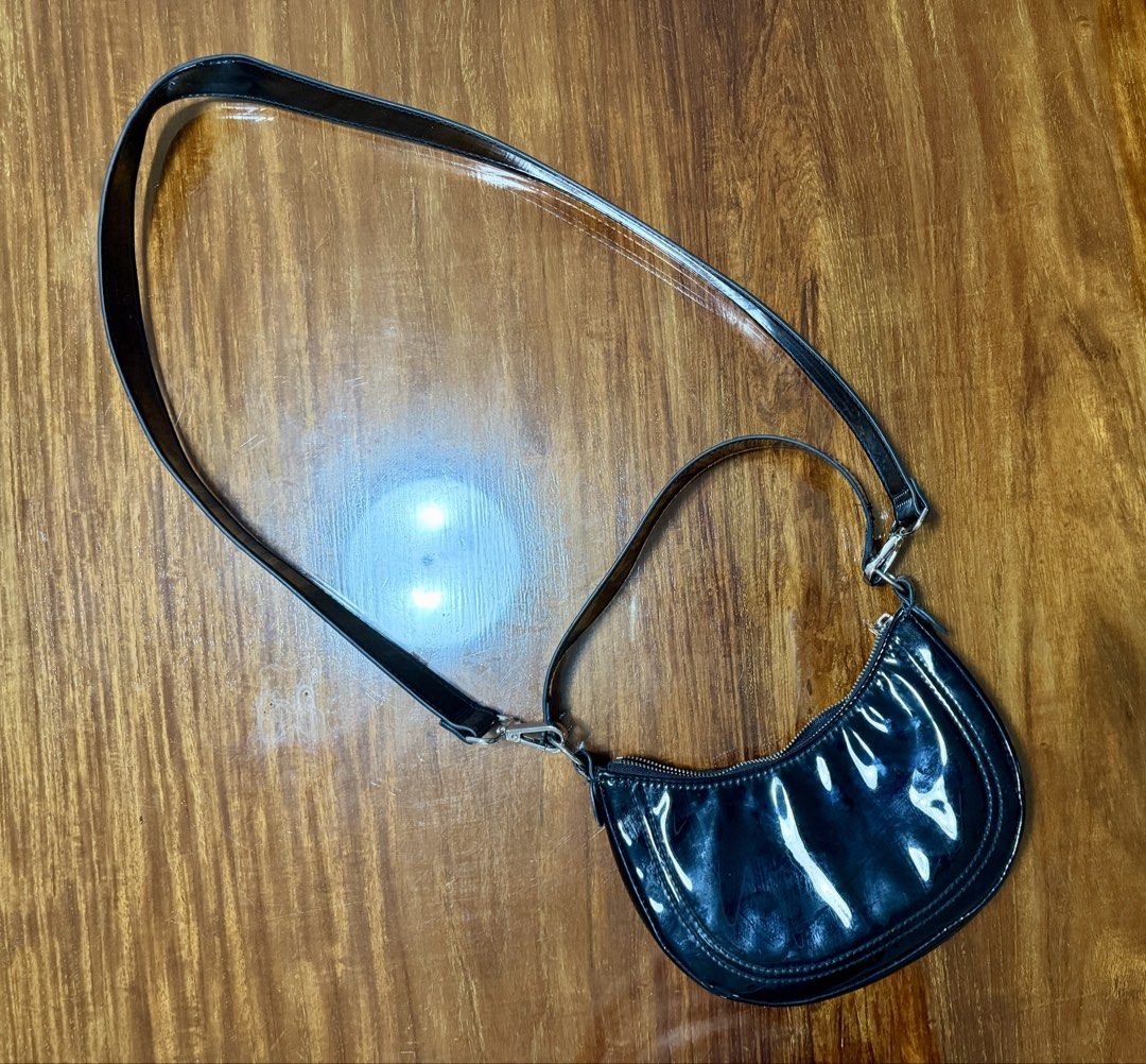 H&M Black Shoulder Bag 2-in-1 (Category: Shoulder Bags) located in Quezon City. Submitted by jikakita (Listing ID 1470170078, Image 1). Description: ✨ H&M Black 2-in-1 Crescent Shoulder Bag • Condition: Like new (used only 1-2 times, well-stored, no issues/flaws) • Color: Glossy Black Details: - Comes with two strap options: a short shoulder strap and a longer adjustable crossbody strap - Can be worn as a shoulder bag, underarm bag, or crossbody 