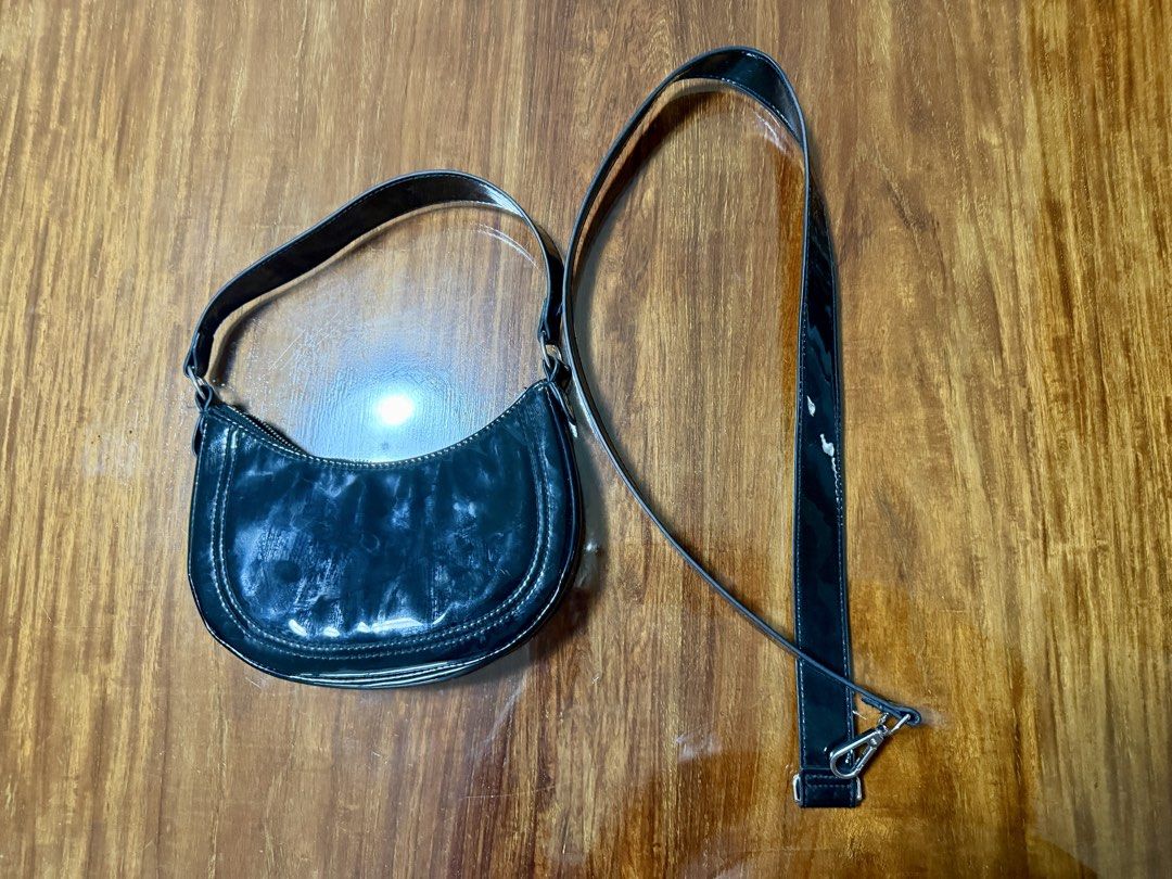 H&M Black Shoulder Bag 2-in-1 (Category: Shoulder Bags) located in Quezon City. Submitted by jikakita (Listing ID 1470170078, Image 3). Description: ✨ H&M Black 2-in-1 Crescent Shoulder Bag • Condition: Like new (used only 1-2 times, well-stored, no issues/flaws) • Color: Glossy Black Details: - Comes with two strap options: a short shoulder strap and a longer adjustable crossbody strap - Can be worn as a shoulder bag, underarm bag, or crossbody 