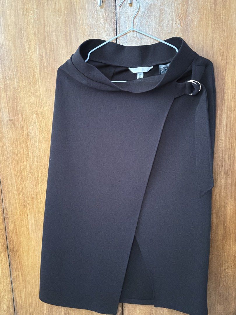 H&M Black Wrap Skirt Size S (Category: Skirts) located in Cavite. Submitted by quickdeer_f75623 (Listing ID 1470166076, Image 1). Description: - Brand: H&M - Size: S (EUR S, US S) - Color: Solid black - Style: Midi length wrap skirt with side belt detail and metal ring closure - Material: Comfortable and stretchy polyester blend - Versatility: Easy to style for office wear or casual outings - Condition: Excellent, no flaws noticed.