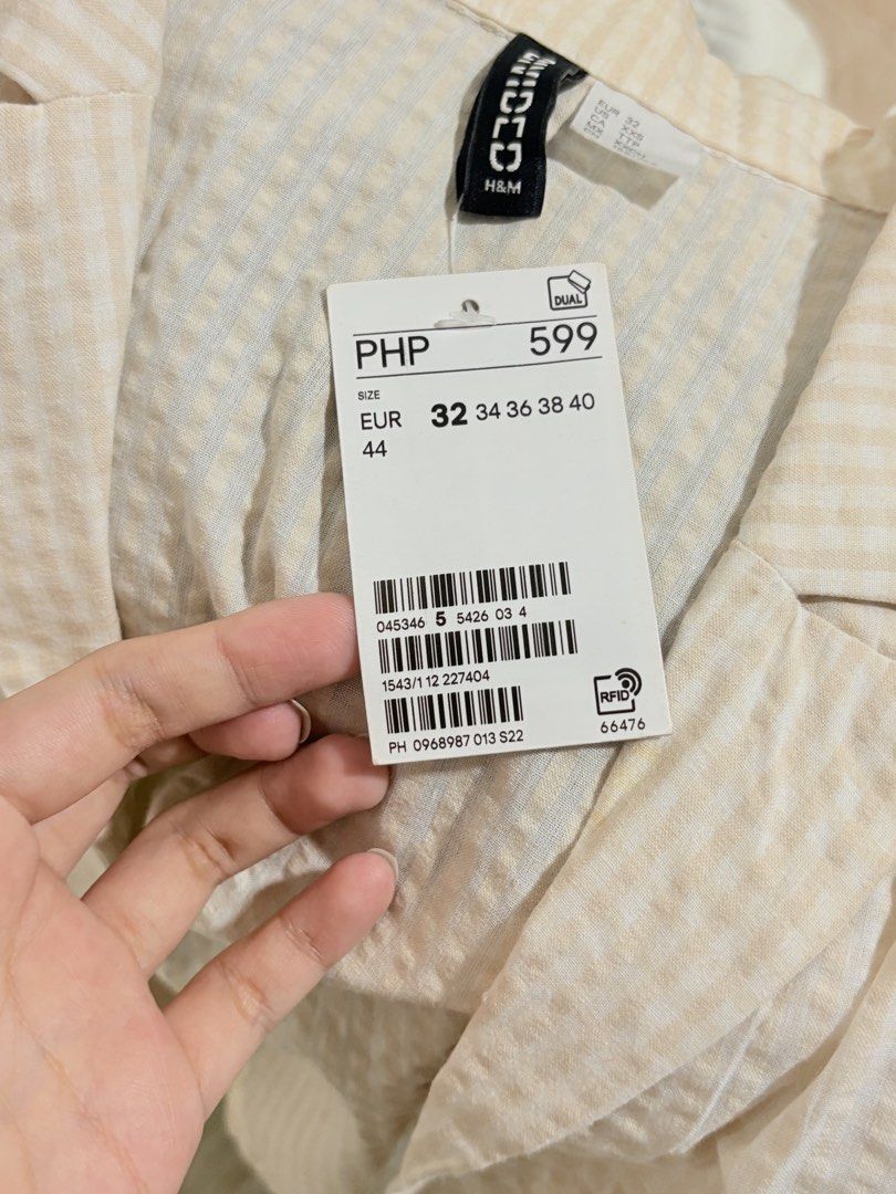 H&M Gingham Crop Blazer Beige White Size XXS (Category: Blouses) located in Manila. Submitted by biacakes (Listing ID 1470260030, Image 3). Description: - Brand: H&M - Style: Cropped blazer / short-sleeve jacket with lapel collar - Pattern: Beige and white checkered gingham - Size: 32 (XXS) - Tag still attached - Material: Lightweight textured fabric - Condition: Brand new with tags (BNWT) - Versatility: Great layering piece for casual and smart-