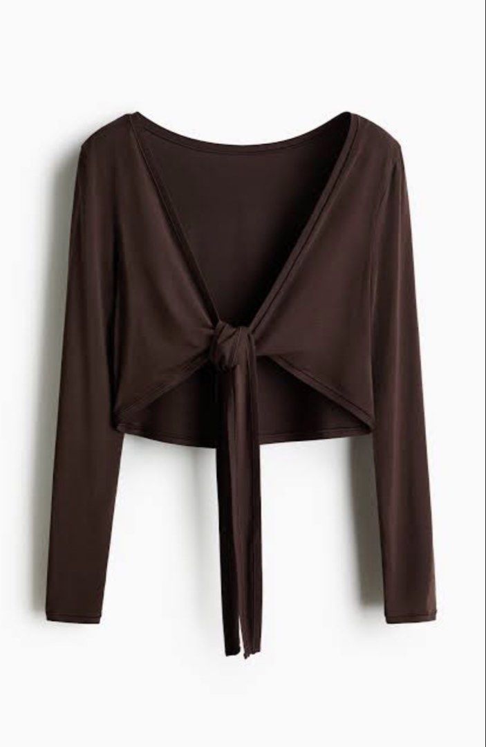 H&M Move Brown Long Sleeve Wrap Front Tie Crop Top (Category: Activewear) located in Makati City. Submitted by regalbbb (Listing ID 1470320264, Image 3). Description: Original Price: Can't remember RFS: Decluttering Condition: No flaws, never used in - Color: Rich brown - Style: Long-sleeve crop top with wrap front and secure center tie - Neckline: Scoop neckline in the back - Material: Smooth and stretchy fabric for all-day comfort - Versatility