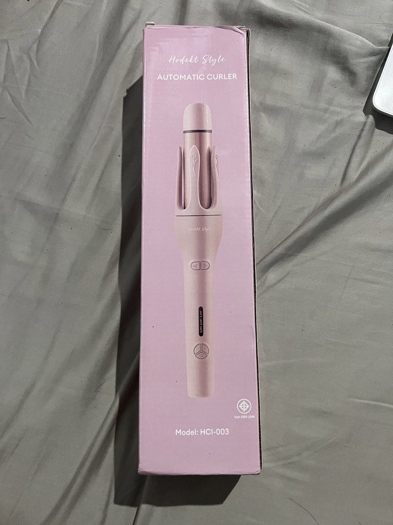 Hodekt Style Automatic Curler Model HCI-003 (Category: Hair) located in Botolan. Submitted by arrietafrancinealexis (Listing ID 1470303300, Image 1). Description: - Brand/Model: Hodekt Style Automatic Hair Curler (HCI-003) - Color: Chic Pink and Rose Gold - Temperature Range: Adjustable from 160°C to 200°C with clear handle display - Easy Styling: Left and right directional buttons for versatile curls - Inclusions: Complete with original box and 