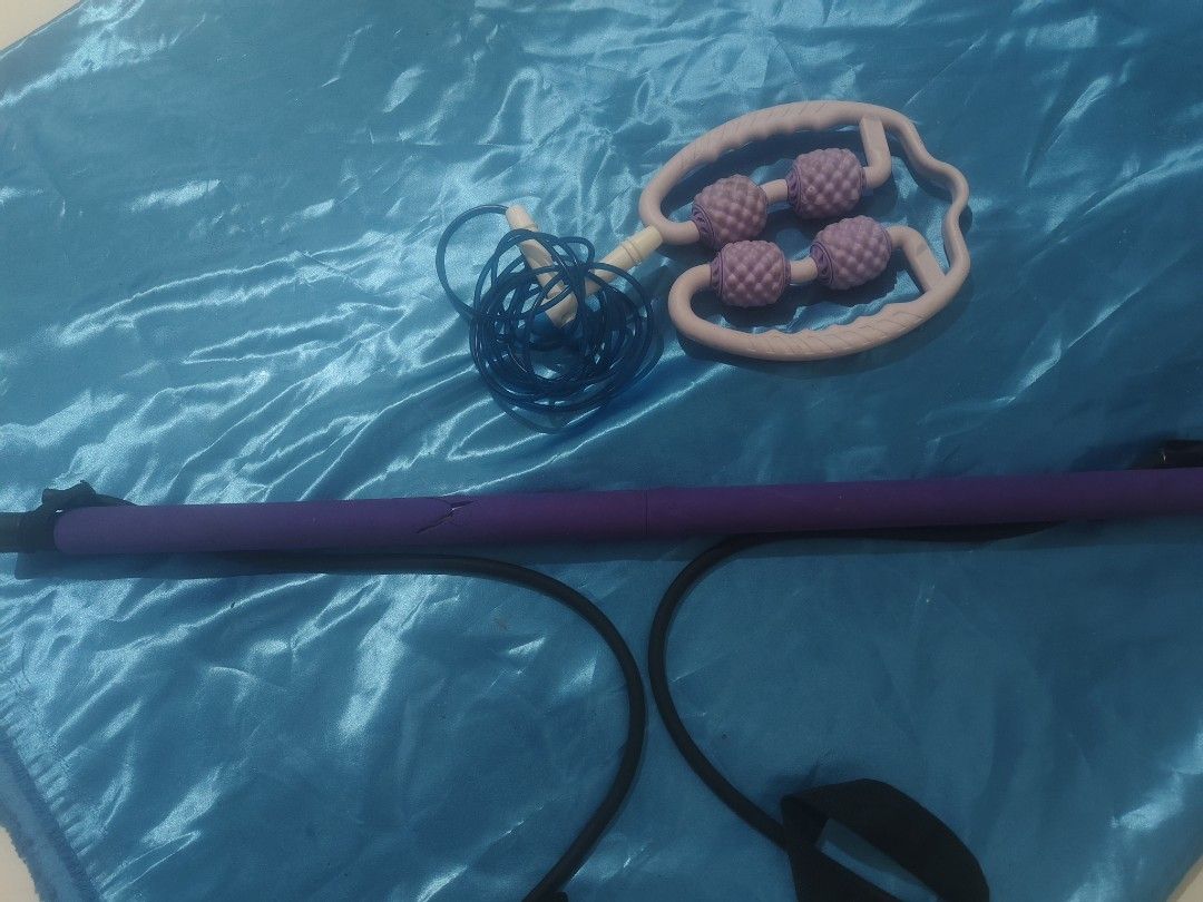 Home Workout Bundle Pilates Bar Roller Skipping Rope (Category: Toning & Stretching Accessories) located in Bulacan. Submitted by babz30261 (Listing ID 1470262355, Image 3). Description: Bundle includes a purple pilates resistance bar with attached black bands, a blue skipping rope, and a purple 4-wheel muscle massage roller. Great set for full body stretching, toning, and recovery at home. Everything packs up easily and takes up minimal space. U