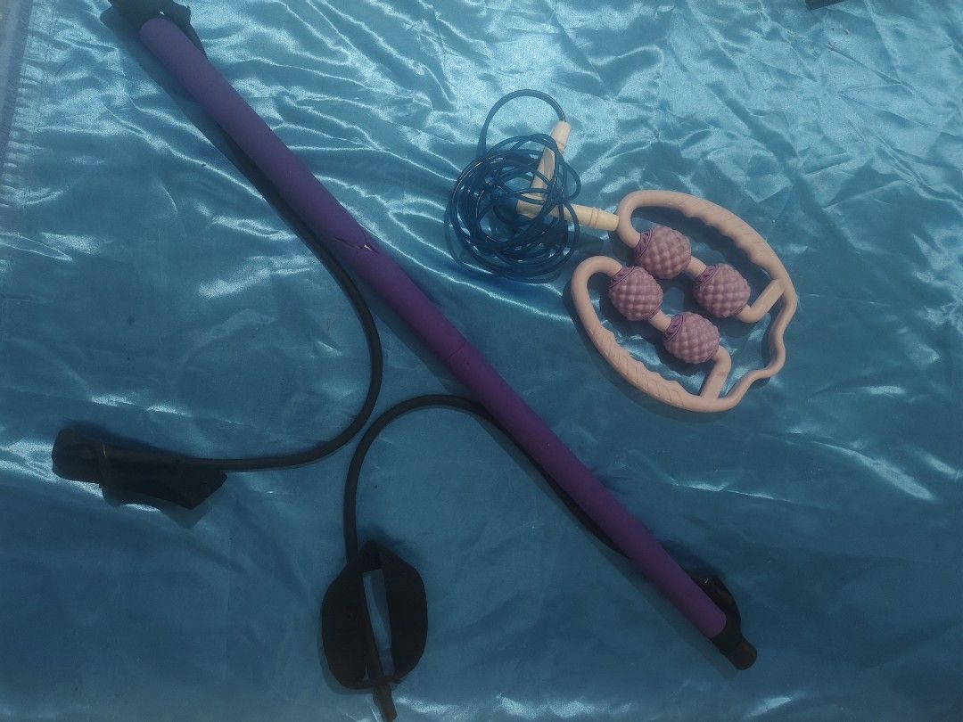 Home Workout Bundle Pilates Bar Roller Skipping Rope (Category: Toning & Stretching Accessories) located in Bulacan. Submitted by babz30261 (Listing ID 1470262355, Image 2). Description: Bundle includes a purple pilates resistance bar with attached black bands, a blue skipping rope, and a purple 4-wheel muscle massage roller. Great set for full body stretching, toning, and recovery at home. Everything packs up easily and takes up minimal space. U