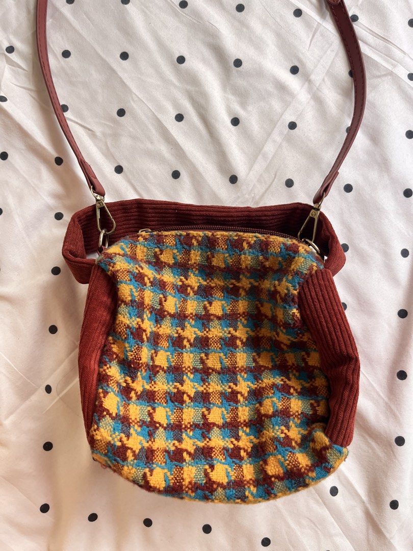 Houndstooth Pattern Crossbody Bag with Corduroy Trim and Strap (Category: Cross-body Bags) located in Manila. Submitted by chimcheese (Listing ID 1470154252, Image 3). Description: - Eye-catching multi-colored houndstooth pattern in blue, yellow, and brown - Stylish deep red corduroy trim and matching red adjustable faux leather strap - Convenient lobster clasp strap attachments for easy removal - Secure zip-top closure to keep your belongings sa