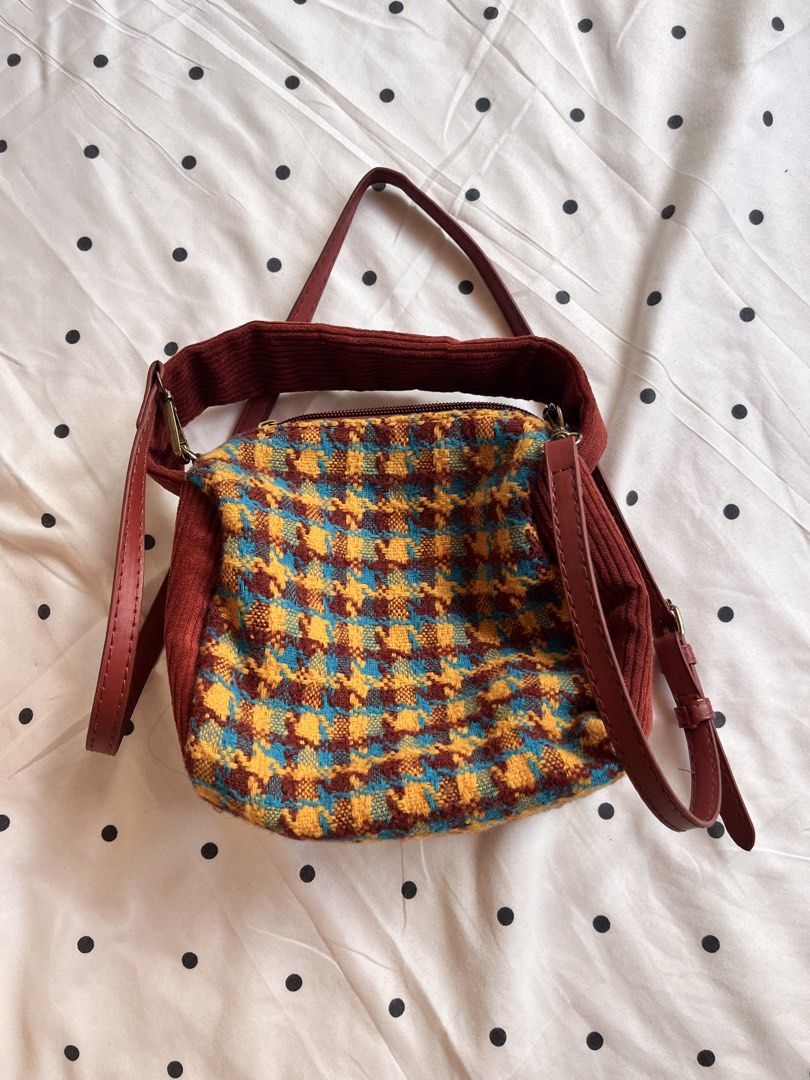 Houndstooth Pattern Crossbody Bag with Corduroy Trim and Strap (Category: Cross-body Bags) located in Manila. Submitted by chimcheese (Listing ID 1470154252, Image 2). Description: - Eye-catching multi-colored houndstooth pattern in blue, yellow, and brown - Stylish deep red corduroy trim and matching red adjustable faux leather strap - Convenient lobster clasp strap attachments for easy removal - Secure zip-top closure to keep your belongings sa