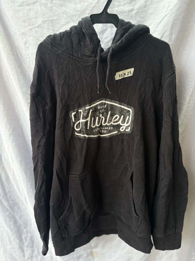 Hurley Surf Co. Black Pullover Hoodie Size M (Category: Hoodies) located in Caloocan City. Submitted by jerksz (Listing ID 1470218588, Image 1). Description: - Brand: Hurley - Color: Black with large white chest graphic - Size: Medium (tag attached) - Material: Comfortable cotton blend, made in Bangladesh - Features: Front kangaroo pocket, adjustable drawstring hood with metal eyelets - Condition: Great for daily casual wear and cooler weather.