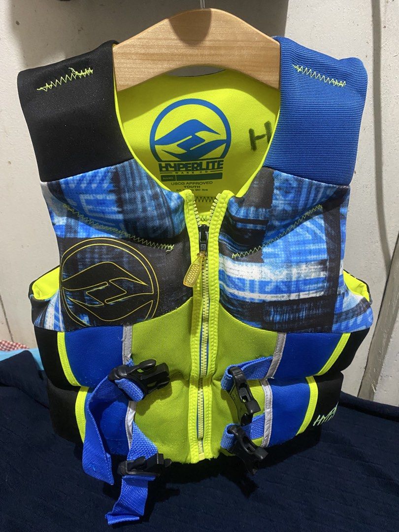 Hyperlite Wake Co Youth Ski Vest PFD Life Jacket (Category: Water Sports) located in Manila. Submitted by resi.diaz (Listing ID 1470317770, Image 1). Description: - Brand: Hyperlite - Certification: USCG approved Type III flotation aid - Size: Youth, fits 50 to 90 lbs (23 to 41 kg) - Design: Bright neon yellow, blue, and black colorway with cool plaid graphic panels - Closure: Front zipper paired with adjustable buckle straps for a secure and snu