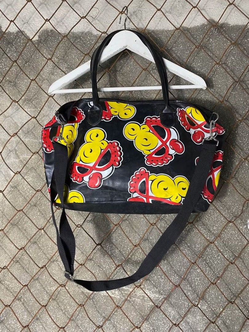 HYSTERIC MINI 2WAY BAG (Category: Tote Bags) located in Quezon City. Submitted by reinellsai49218 (Listing ID 1470179803, Image 3). Description: - Eye-catching streetwear design with vibrant yellow and red character graphics - Durable black synthetic material built for everyday use - Secure top zipper closure to keep your belongings safe - Spacious interior with plenty of room for daily essentials - Versatile carrying options with dual top handle