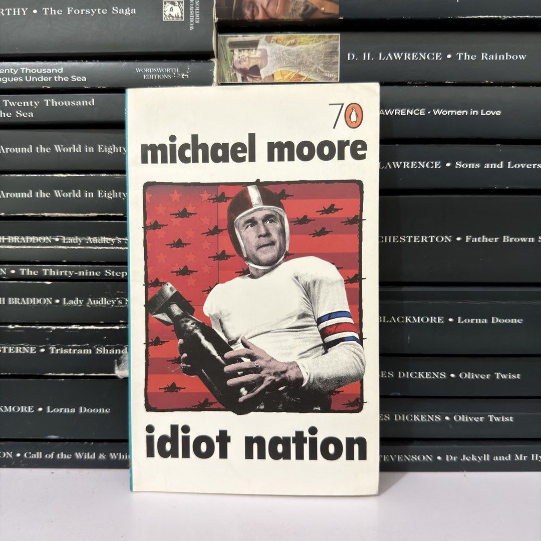 Idiot Nation by Michael Moore Paperback Book (Category: Storybooks) located in Lingayen. Submitted by readwjane (Listing ID 1470153901, Image 1). Description: - Title: Idiot Nation by Michael Moore - Publisher: Penguin Books - Format: Paperback - Cover: George W. Bush in a football helmet holding a bomb - Condition: Pages intact with light shelf wear along the edges - Great addition for political commentary fans.