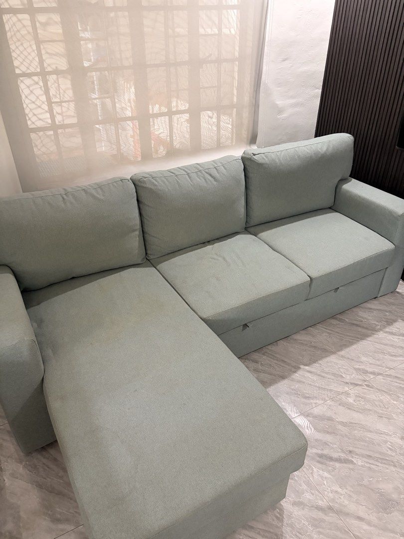 Ikea L-Shaped Sofa Bed (Category: Sofas) located in Taguig. Submitted by jesrm (Listing ID 1470251722, Image 2). Description: - Color: Light sage green - Material: Comfortable fabric upholstery with removable cushions - Features: Built-in pull-out bed Has few stains .