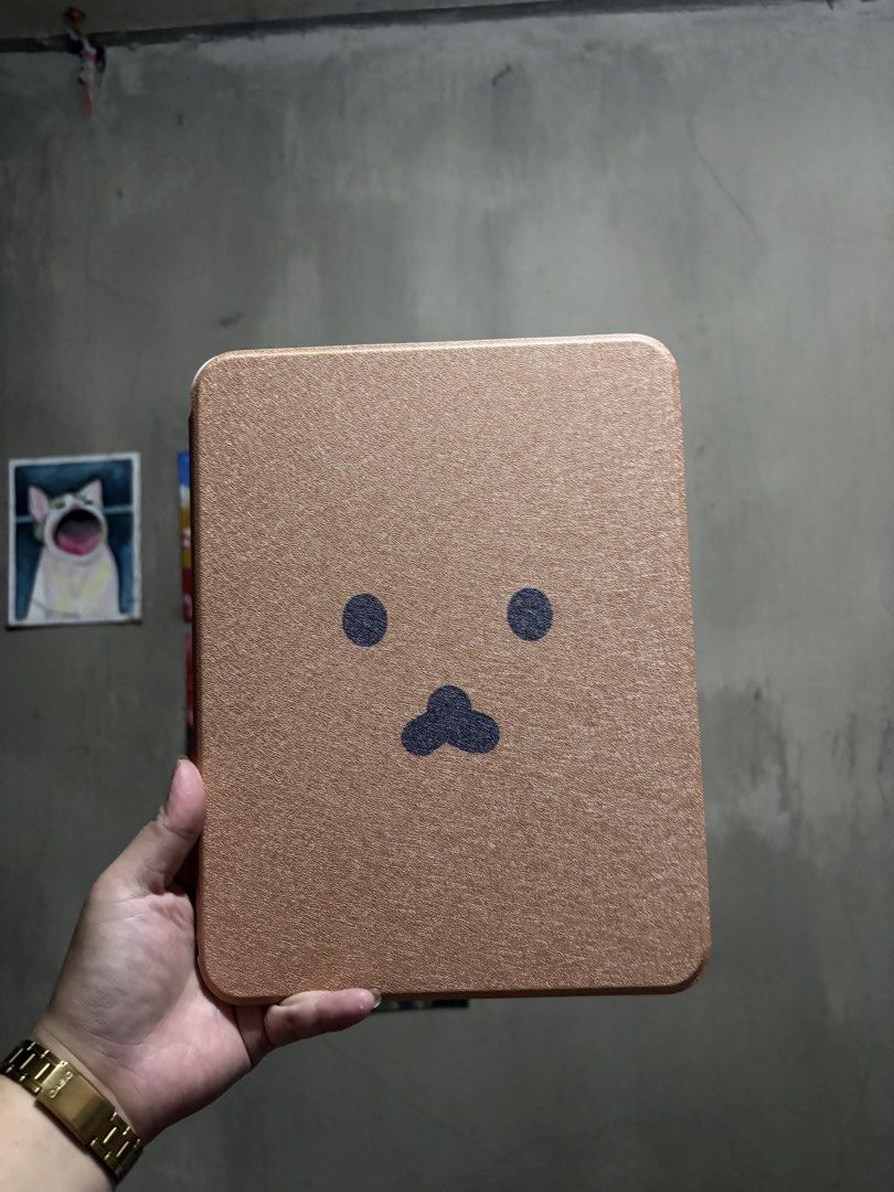 IPAD 10.9in A19 and 10th gen case (Category: Cases & Sleeves) located in Manila. Submitted by royalpengwen (Listing ID 1470306869, Image 1). Description: - Compatible with iPad 10.9-inch (10th Generation) - Cute brown front cover with minimalist character design - Transparent back case adorned with aesthetic stickers - 360-degree rotation support for multi-angle viewing (portrait and landscape) - Sturdy build for everyday protection against scrat