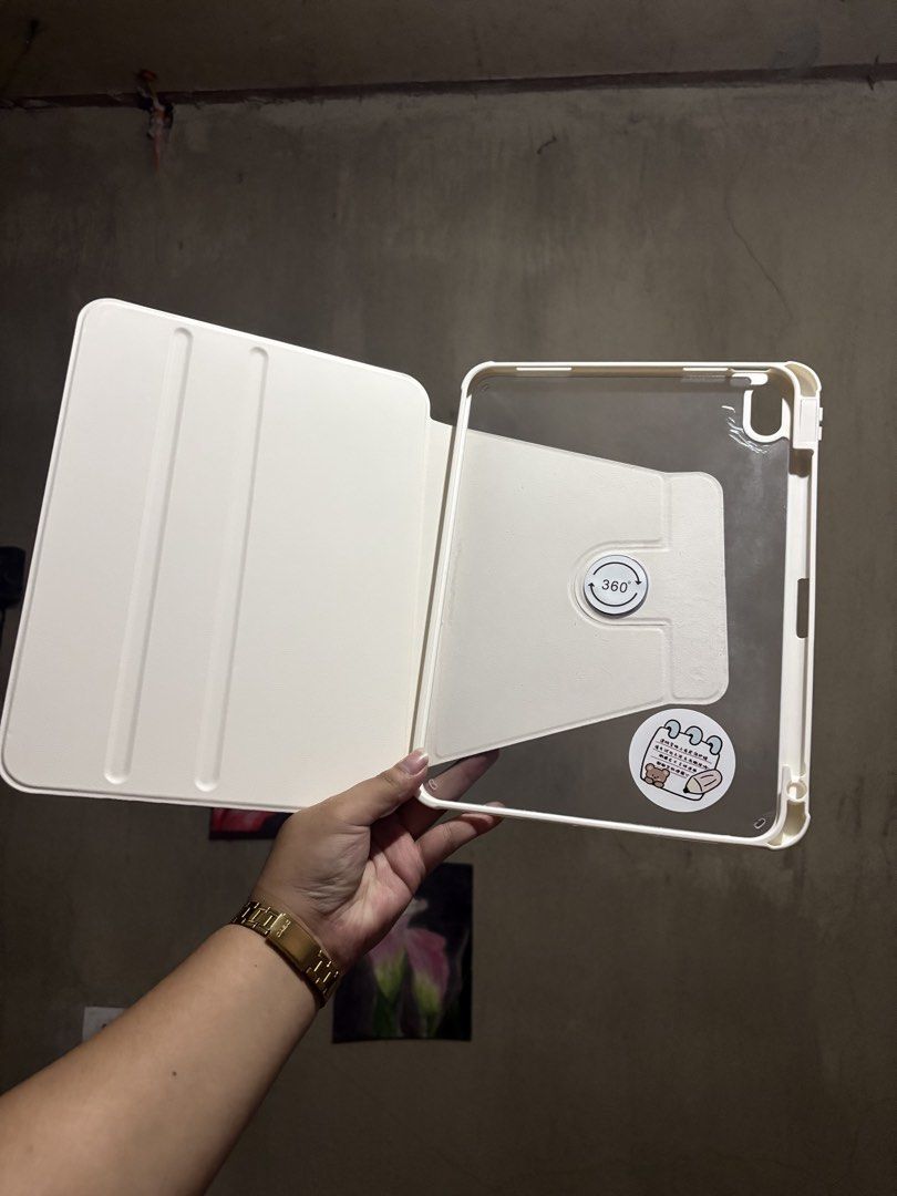 IPAD 10.9in A19 and 10th gen case (Category: Cases & Sleeves) located in Manila. Submitted by royalpengwen (Listing ID 1470306869, Image 3). Description: - Compatible with iPad 10.9-inch (10th Generation) - Cute brown front cover with minimalist character design - Transparent back case adorned with aesthetic stickers - 360-degree rotation support for multi-angle viewing (portrait and landscape) - Sturdy build for everyday protection against scrat