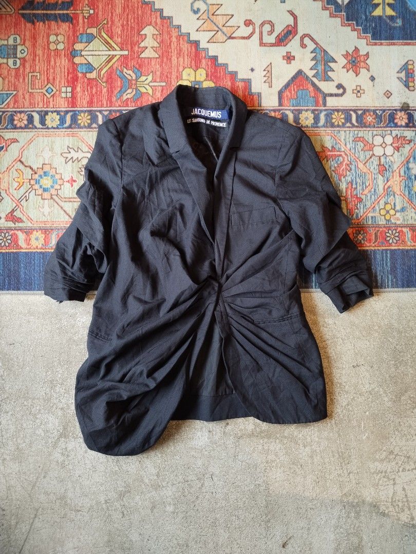 Jacquemus Les Santons De Provence Black Blazer (Category: Coats, Jackets and Outerwear) located in Pasig City. Submitted by loveforlux_2025 (Listing ID 1470236837, Image 1). Description: - Authentic Jacquemus designer blazer in a versatile black colorway - Unique front twisting drape design with structured lapels - Equipped with two flap pockets and one chest pocket - Expertly crafted in Bulgaria with premium construction - Features branded inter