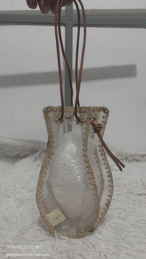 JAMIRAY POT PATCHWORK TRANSPARENT BAG (Category: Tote Bags) located in Kalibo. Submitted by secondchances.thriftsh8p (Listing ID 1470313361, Image 2). Description: - Brand/Model: JAMIRAY pot patchwork bag - Material: Clear vinyl with beige crochet trim and brown leather accents - Closure & Straps: Secure leather drawstring and slender shoulder straps - Design: Unique vase-shaped bucket bag with a small logo tag - Best For: Casual outings, beach t