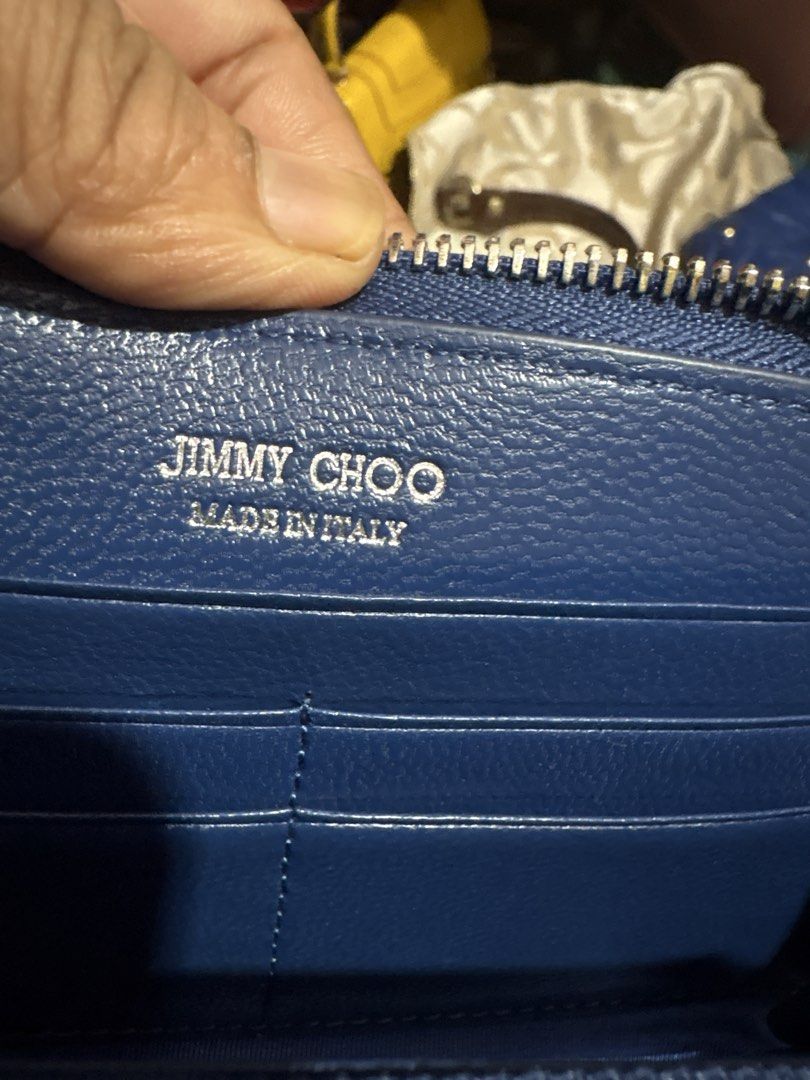 Jimmy Choo (Category: Wallets & Card holders) located in Cordova. Submitted by cb_bagz_n_bloom (Listing ID 1470308451, Image 2). Description: Chic deep blue zip-around wallet featuring edgy silver star studs. Offers plenty of space for cards and cash. A stylish and practical everyday accessory with great character!.