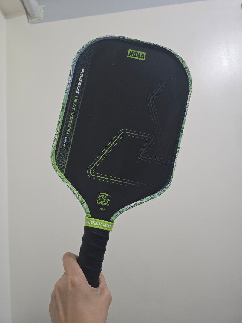 JOOLA Perseus Heat Vision Pickleball Paddle (Category: Racket and Ball Sports) located in Quezon City. Submitted by randomgoods13 (Listing ID 1470210537, Image 2). Description: - Model: JOOLA Perseus Heat Vision (16mm thickness) - Color: Surge Green with black face and patterned edge guard - Grip: Standard grip with black overgrip - Certification: USA Pickleball approved Original Price: ₱7,195 Date Purchased: August 2026 Usage: Played approximate
