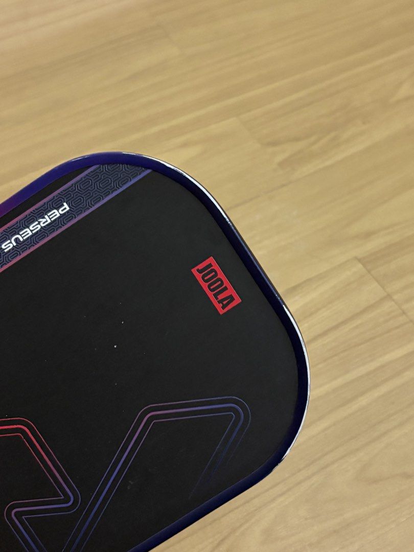 Joola Perseus Heat Vision Pickleball Paddle (Category: Racket and Ball Sports) located in Pasig City. Submitted by beldc (Listing ID 1470271454, Image 2). Description: Well used Joola Perseus Heat Vision Pickleball Paddle in color red. Bought last April 2026 from Stride & Stroke Glorietta for almost 6500. I play in Open plays x1 a week only so do the math. With visible scratches and ball marks as shown in the photo. With newly placed Kawasaki gri