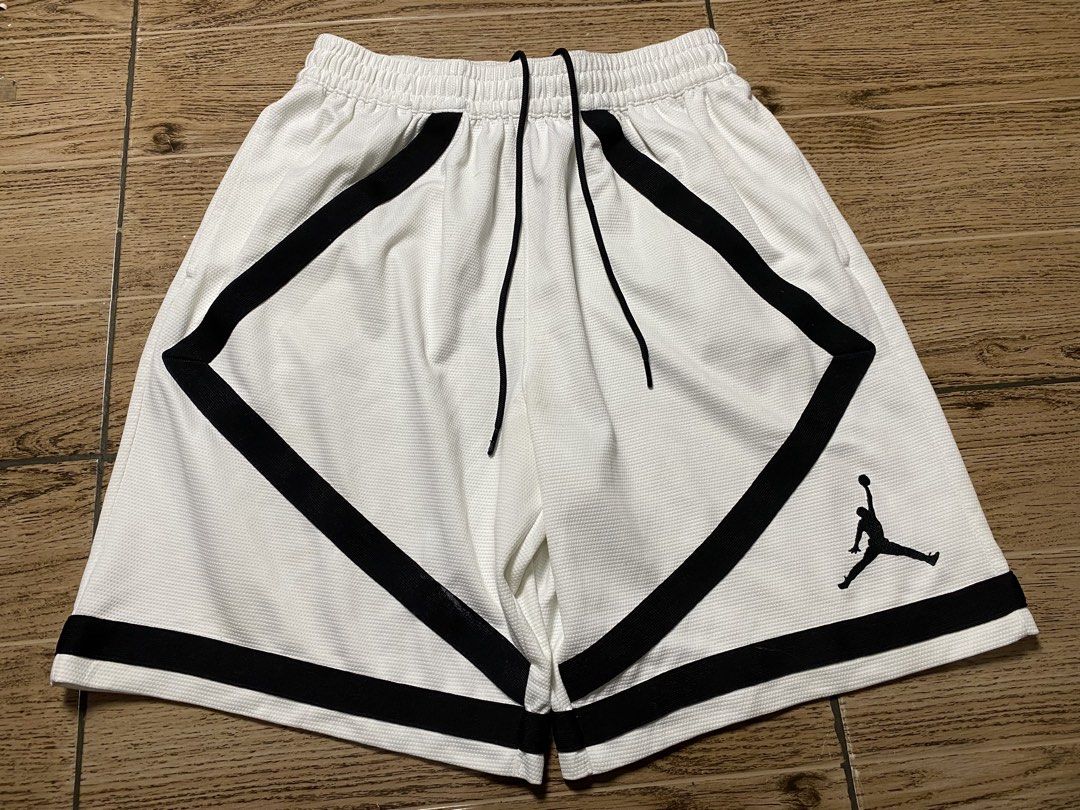 Jordan “Bermuda”Basketball Short (Category: Shorts) located in Binalbagan. Submitted by southsidethrift22 (Listing ID 1470285497, Image 1). Description: - Color & Style: White mesh basketball shorts with black diamond stripes and embroidered Jumpman logo - Fit: Comfortable elastic drawstring waistband - Condition: Minor yellow staining near the crotch seam and slight wear on the black side panel tape (refer to closeups) - Versatility: Breathable 