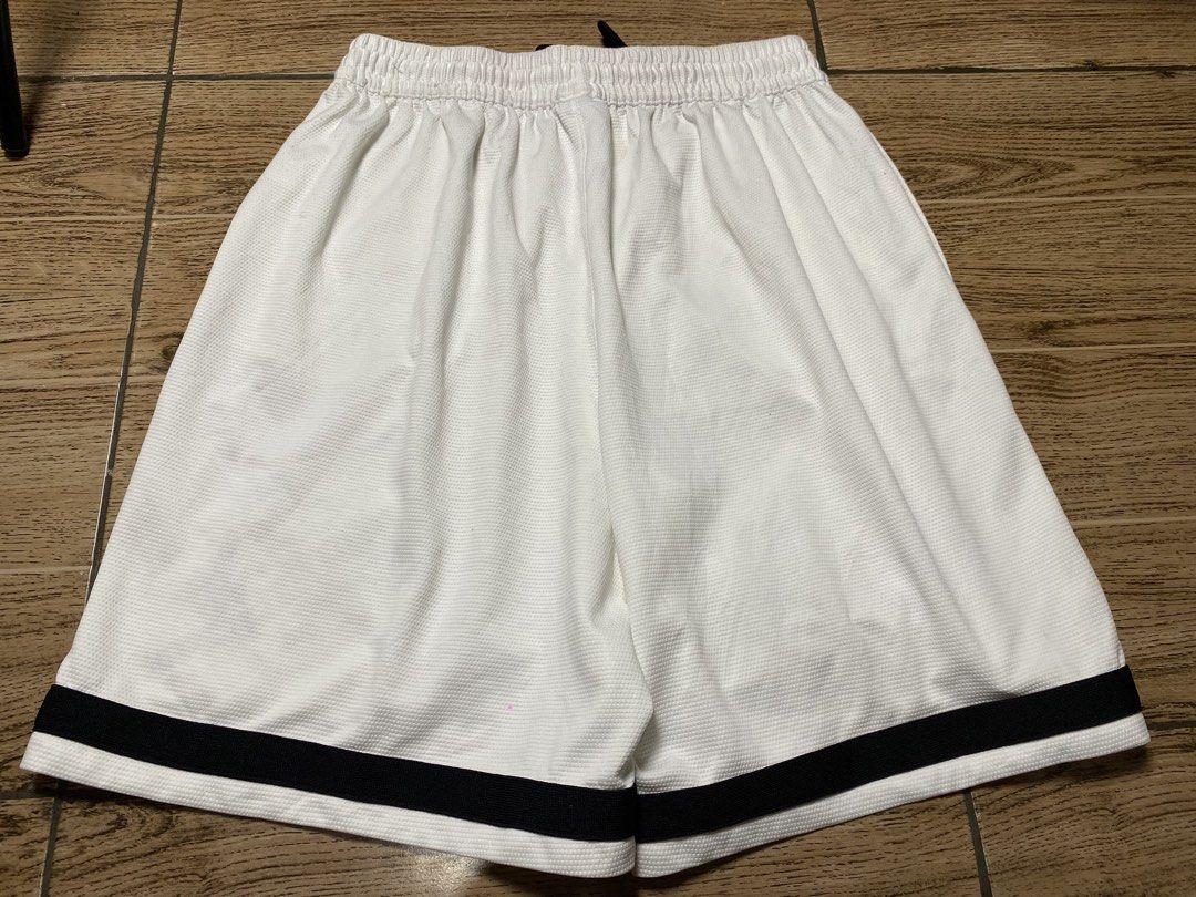 Jordan “Bermuda”Basketball Short (Category: Shorts) located in Binalbagan. Submitted by southsidethrift22 (Listing ID 1470285497, Image 2). Description: - Color & Style: White mesh basketball shorts with black diamond stripes and embroidered Jumpman logo - Fit: Comfortable elastic drawstring waistband - Condition: Minor yellow staining near the crotch seam and slight wear on the black side panel tape (refer to closeups) - Versatility: Breathable 