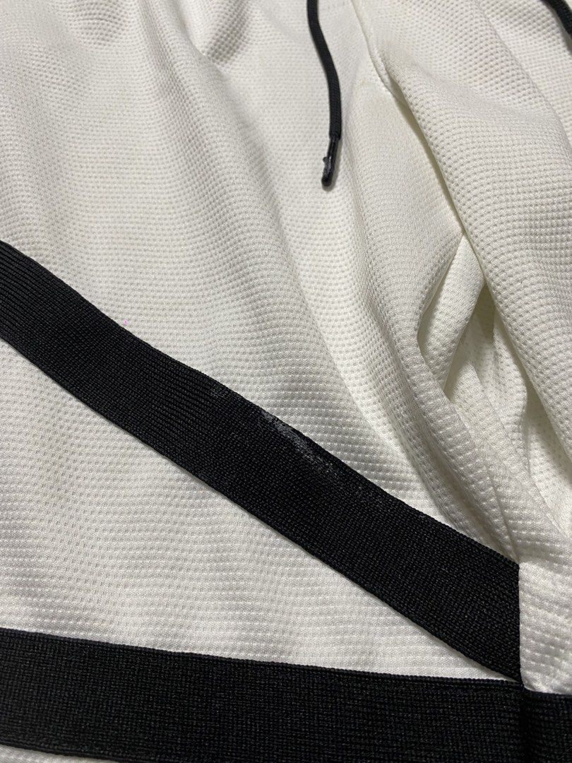 Jordan “Bermuda”Basketball Short (Category: Shorts) located in Binalbagan. Submitted by southsidethrift22 (Listing ID 1470285497, Image 3). Description: - Color & Style: White mesh basketball shorts with black diamond stripes and embroidered Jumpman logo - Fit: Comfortable elastic drawstring waistband - Condition: Minor yellow staining near the crotch seam and slight wear on the black side panel tape (refer to closeups) - Versatility: Breathable 