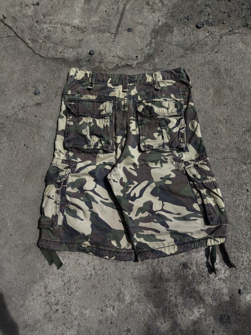 Jordan Craig Camo Cargo Shorts (Category: Shorts) located in Manila. Submitted by maryaganda (Listing ID 1470167287, Image 2). Description: - Brand: Jordan Craig - Design: Camouflage (Green, Brown, Tan) - Material: Heavyweight cotton twill - Pockets: Multiple utility pockets on sides and back - Details: Branded button closure, interior waist label, adjustable drawstring leg hems - Condition: Great streetwear staple for warm weather.