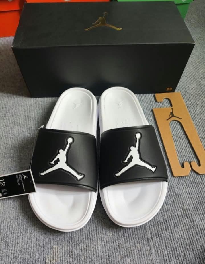 Jordan Jumpman Slides Men (Category: Slippers & Slides) located in Paranaque City. Submitted by d_clutterss (Listing ID 1470338267, Image 1). Description: - Item: Jordan Jumpman Slides - Color: Black and White - Size: US 12 / UK 11 / EUR 46 / CM 30 - Condition: Brand new with original box and tag .