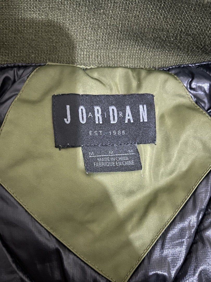 Jordan Olive Green Bomber Jacket Size M (Category: Coats, Jackets and Outerwear) located in Caloocan City. Submitted by noblecat_c04f74 (Listing ID 1470149855, Image 3). Description: - Brand/Model: Jordan bomber jacket - Color: Olive green - Size: Medium - Design: Patches on the front chest and bold text printing on the back - Lining: Quilted black inner lining for extra comfort - Details: Ribbed collar, cuffs, and hem with a full zip closure and