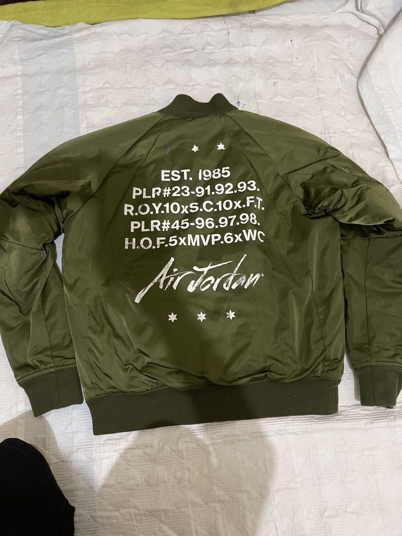 Jordan Olive Green Bomber Jacket Size M (Category: Coats, Jackets and Outerwear) located in Caloocan City. Submitted by noblecat_c04f74 (Listing ID 1470149855, Image 2). Description: - Brand/Model: Jordan bomber jacket - Color: Olive green - Size: Medium - Design: Patches on the front chest and bold text printing on the back - Lining: Quilted black inner lining for extra comfort - Details: Ribbed collar, cuffs, and hem with a full zip closure and
