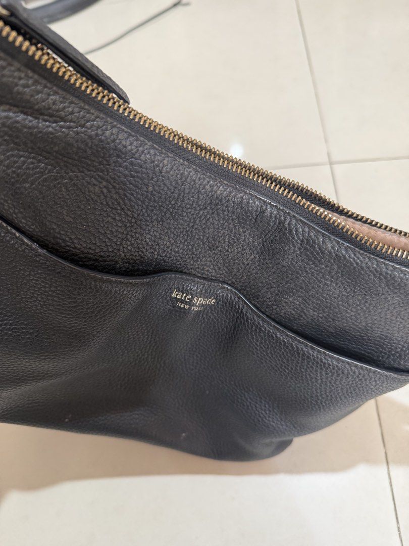 Kate Spade Black Pebbled Leather Shoulder Bag (Category: Luxury Bags & Wallets) located in Paranaque City. Submitted by mryjwll (Listing ID 1470178521, Image 3). Description: - Brand: Kate Spade New York - Material: Premium black pebbled leather with gold-tone hardware - Closure: Secure top zipper closure - Pockets: Convenient front slip pocket with gold foil embossed logo - Details: Signature metal spade logo on the back - Strap: Single shoulder