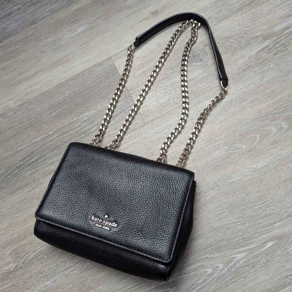 Kate Spade Briar Lane Original (Category: Cross-body Bags) located in Naga. Submitted by forsaleitems2 (Listing ID 1470144781, Image 1). Description: - Brand: Kate Spade New York - Material: Premium black pebbled leather - Closure: Flap with secure magnetic snap - Strap: Elegant chain strap included - Interior: Black monogram fabric lining with leather logo patch - Tags: Includes original fabric care tag and style tag (S338) - Condition: Excellen