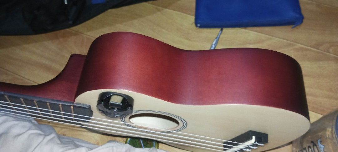 Kawes Ukulele bundle with tuner and picks (Category: Musical Instruments) located in Manila. Submitted by maryros_1996 (Listing ID 1470210809, Image 2). Description: - Kawes acoustic ukulele with a stunning natural wood finish and dark reddish-brown back and sides - Standard fretboard featuring white dot markers and easy-on-the-fingers nylon strings - Includes a black clip-on digital tuner for accurate and quick tuning - Comes with a set of color