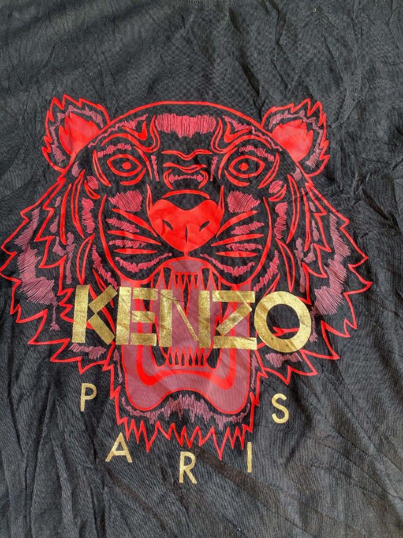 Kenzo Tiger Graphic Black T-Shirt (Category: Tshirts & Polo Shirts ) located in Manila. Submitted by nadyrl (Listing ID 1470307701, Image 2). Description: - Brand: Kenzo - Color: Black - Size: XXL (Relaxed casual fit) - Material: 100% Cotton - Design: Large red and gold tiger graphic print with Paris branding - Neckline: Crew neck - Origin: Made in Portugal - Style Code: F855TS0504Y7.